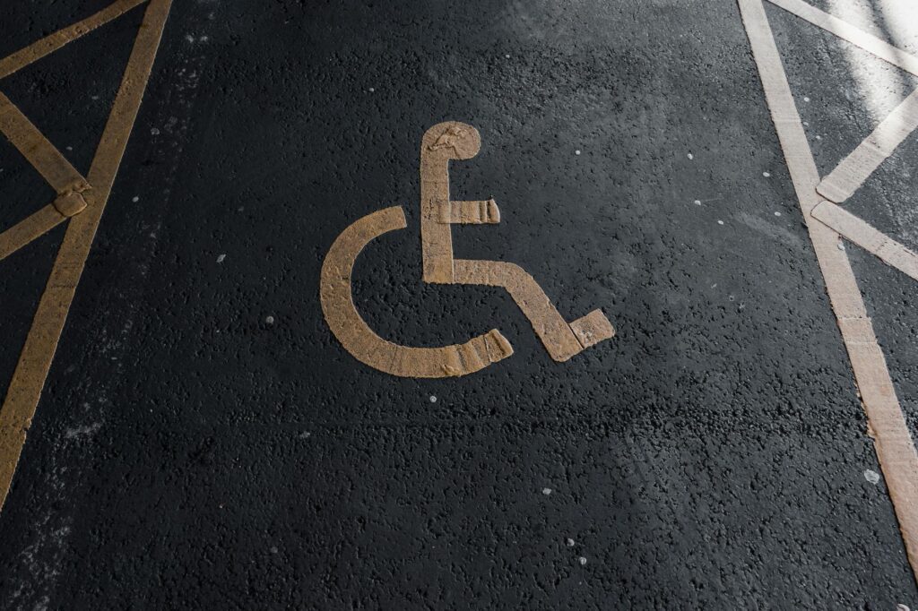 Close-up of a handicapped parking sign painted on pavement for accessibility clarity.