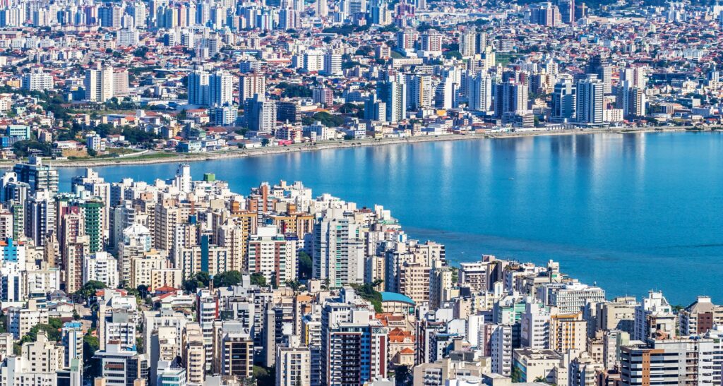 Dynamic aerial view of Florianópolis, Brazil showcasing urban waterfront and vibrant cityscape.
