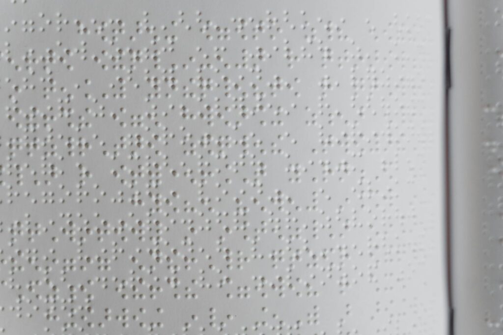 Detailed close-up of embossed Braille text, ideal for diversity and accessibility topics.